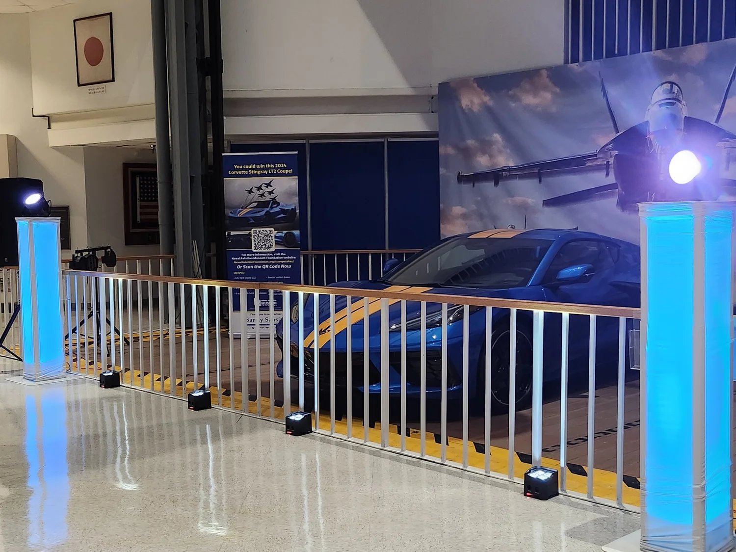Blue LED uplighting around a vehicle display at a corporate showcase