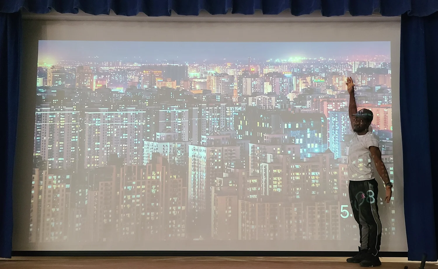 Keynote speaker presenting in front of a large-format projection screen